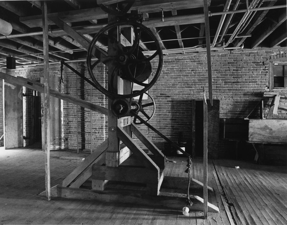 2008.033.850 Tannery equipment remained in place until redevelopment began, like this hoist on the 4th floor (Carmen Truice, 1982).
