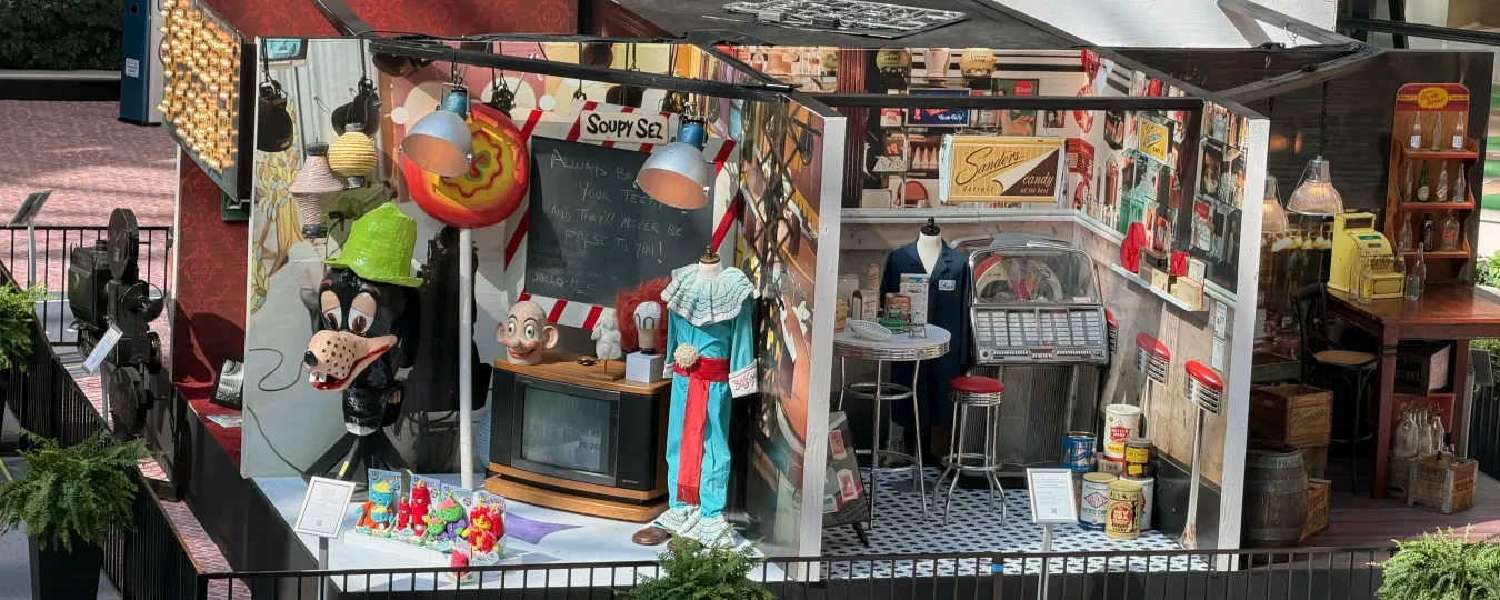 Shopping mall display with carnival games, toys, and colorful decorations.