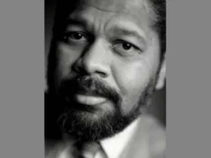 Black and white portrait of a bearded man looking thoughtful.
