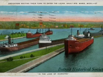 Postcard - Freighters Waiting Their Turn to Enter the Locks, Sault Ste. Marie, Mich. "In The Land of Hiawatha".