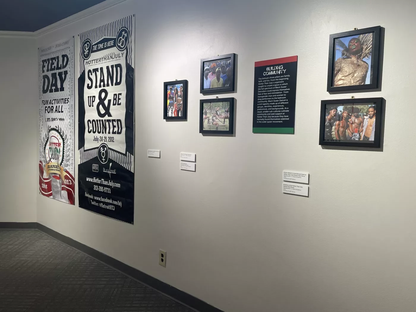 Museum wall with banners and framed photos displayed.