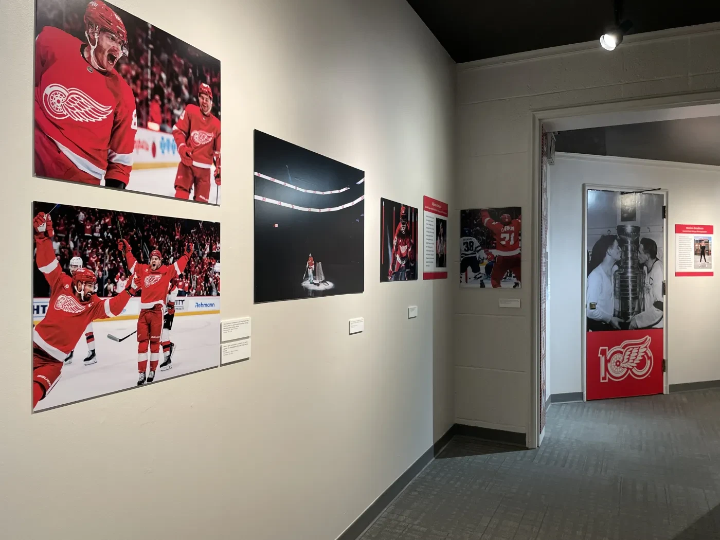 Hockey-themed hallway with action photos, team logos, and memorabilia on display.
