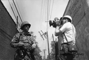 A film crew interviews a National Guardsman. From the Detroit Historical Society Collection.